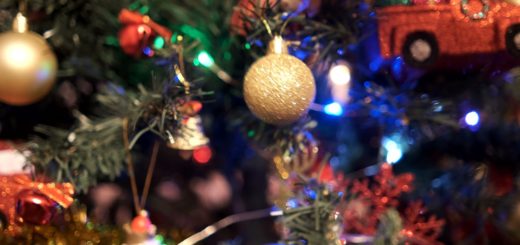 Woman Hangs Up Golden Ornament Ball On Branch Of Christmas Tree Stock Footage